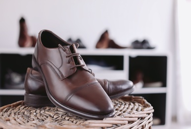 Photo of Male shoes on wicker stand in store