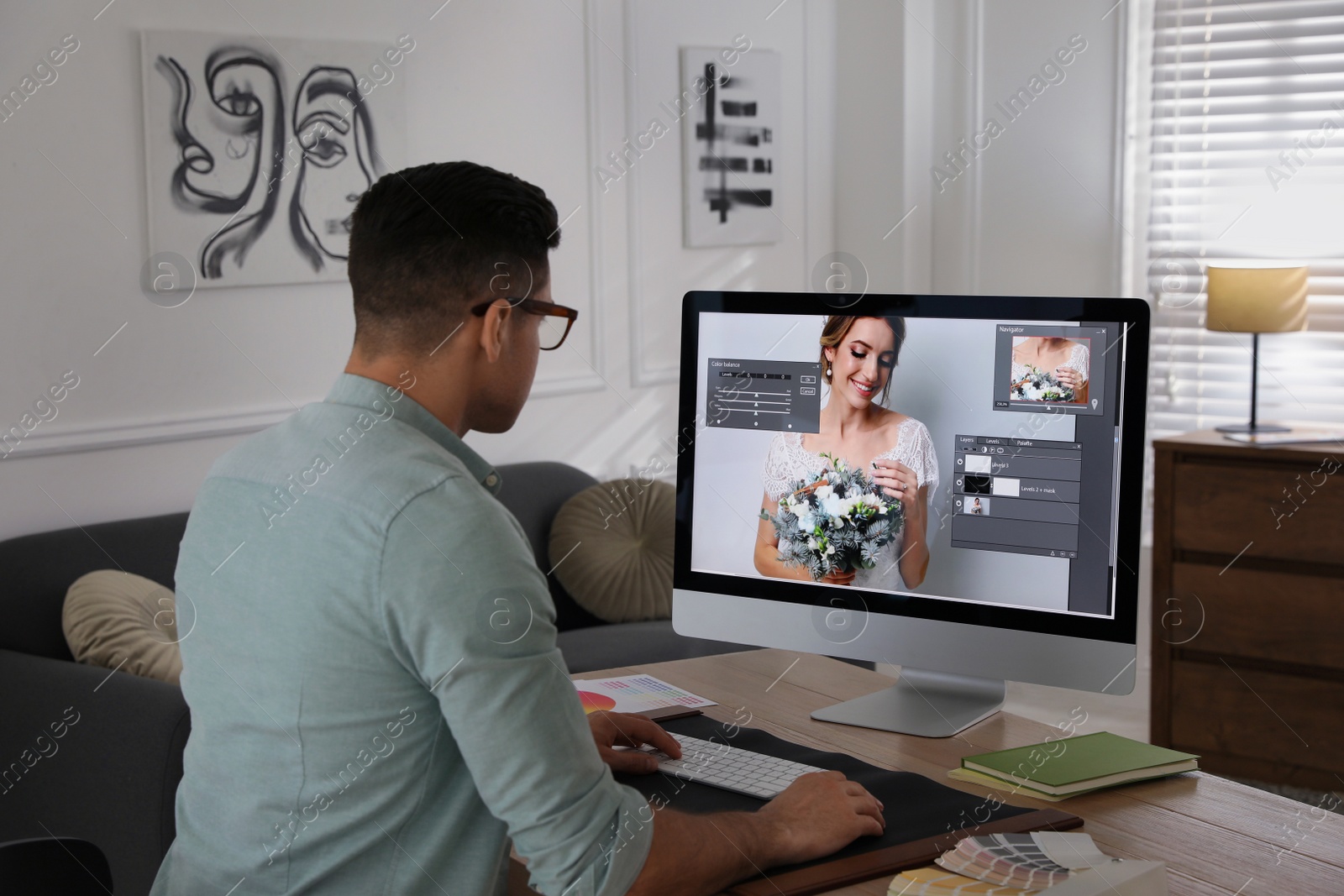 Photo of Professional retoucher working on computer in office