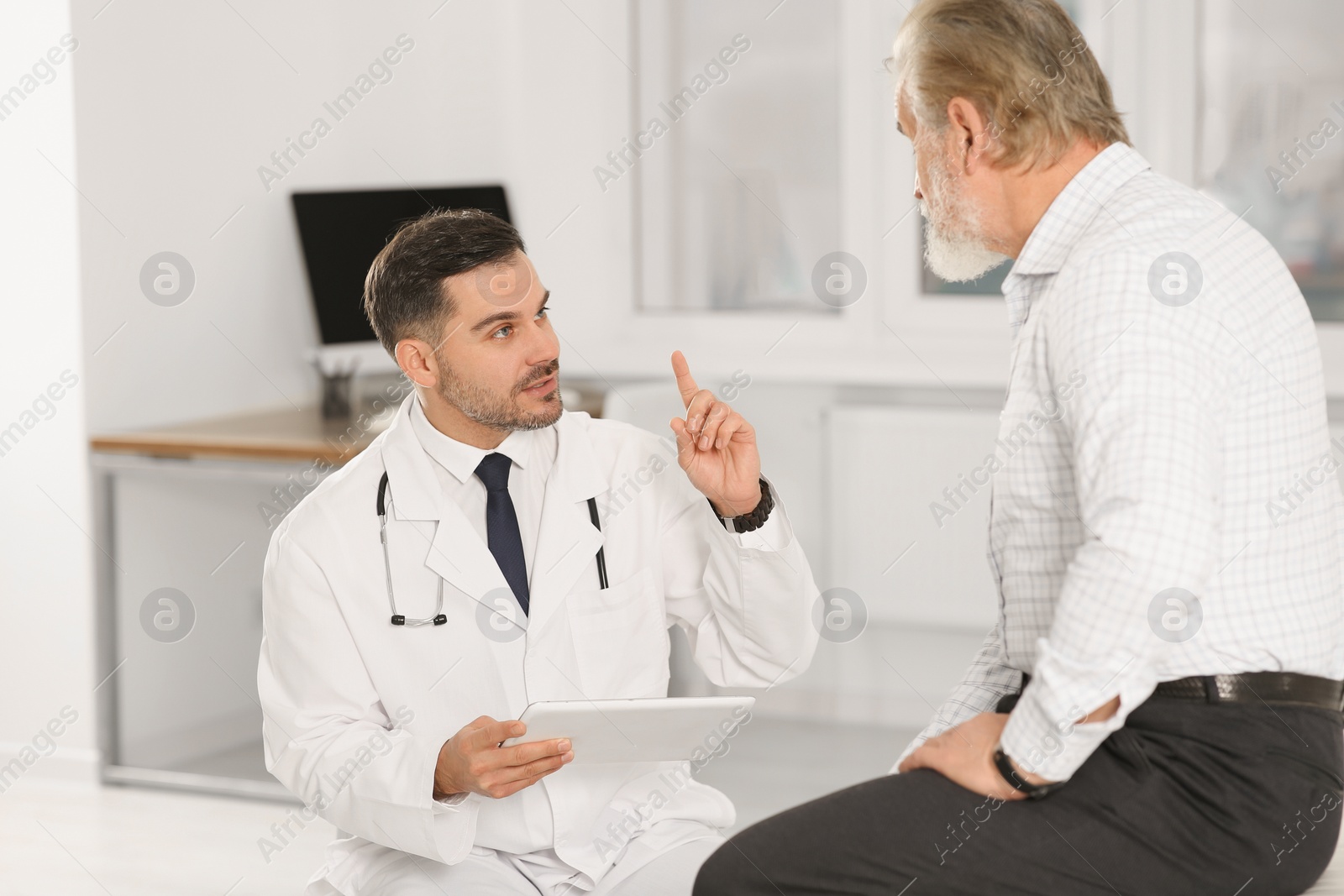 Photo of Senior patient having appointment with doctor in clinic