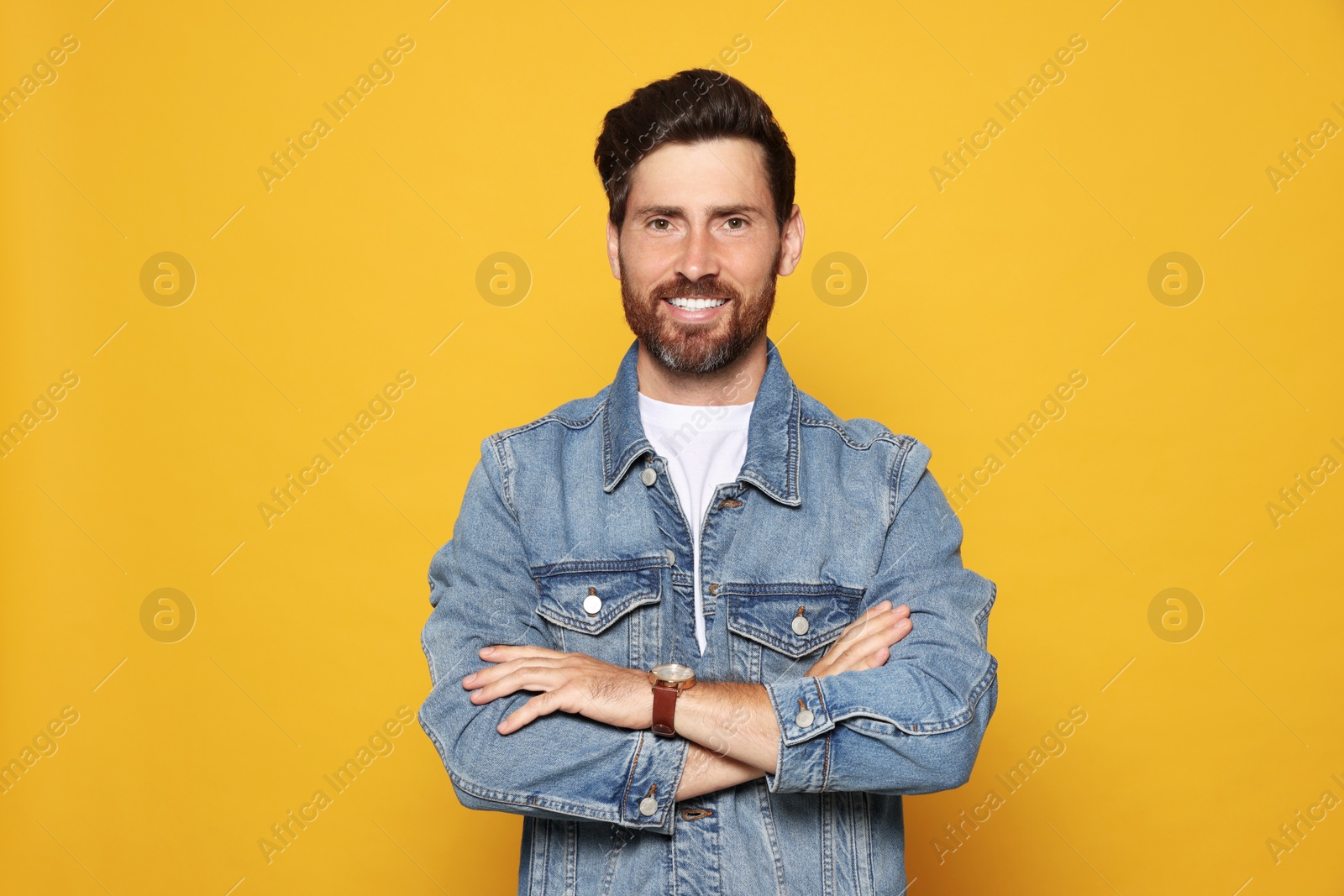 Photo of Portrait of smiling bearded man on orange background