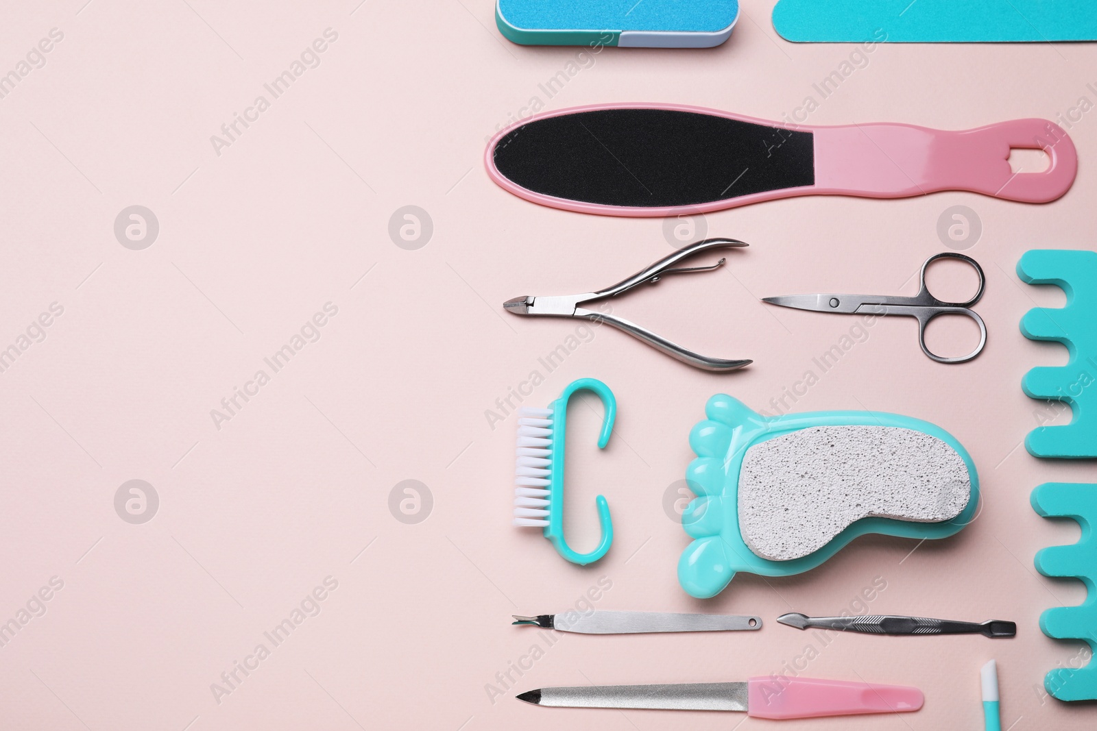 Photo of Set of pedicure tools on pink background, flat lay. Space for text