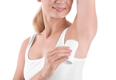 Young woman using deodorant on white background, closeup