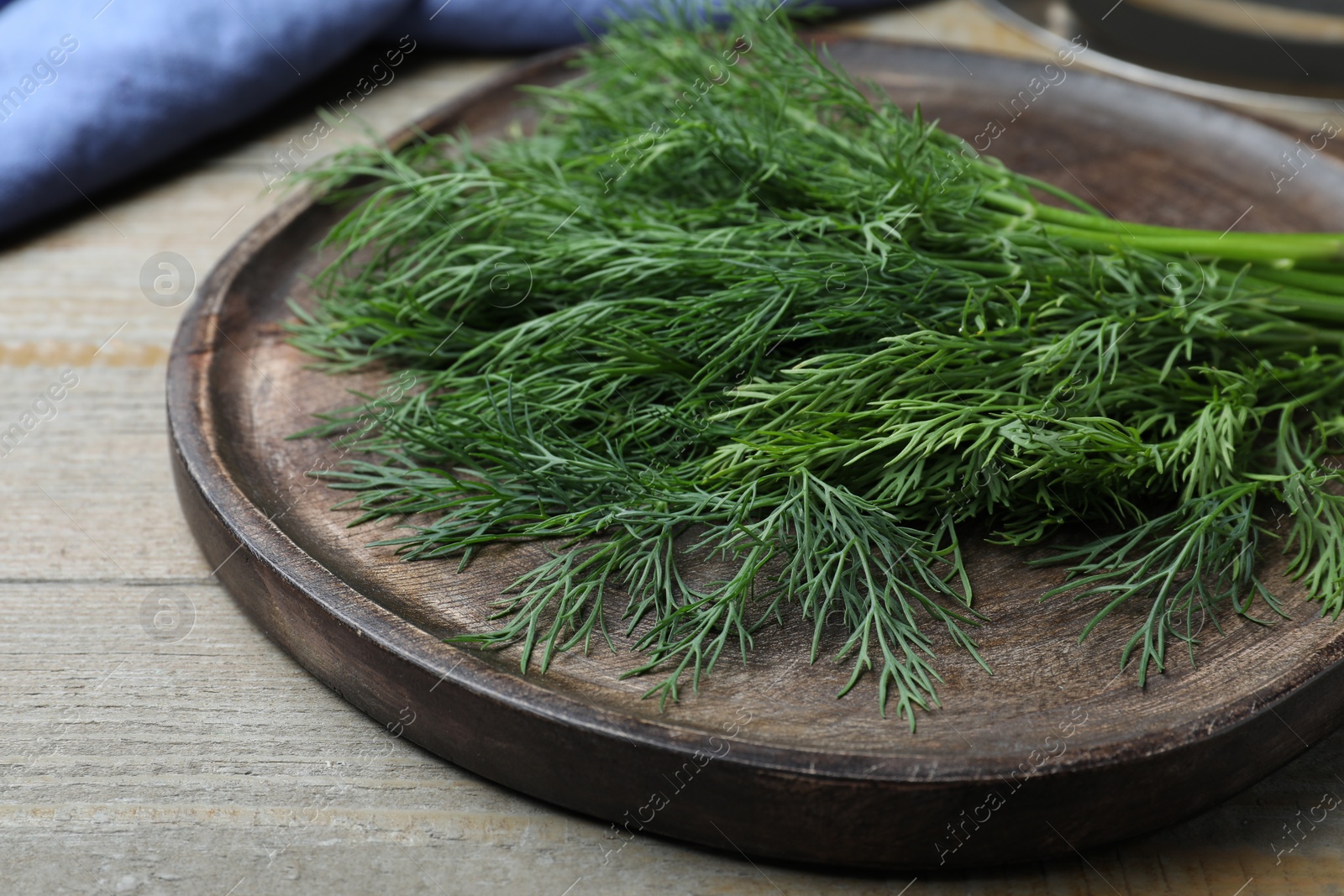 Photo of Bunch of fresh dill on wooden table, closeup