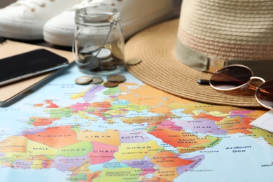 Photo of Different items on world map. Travel during summer vacation