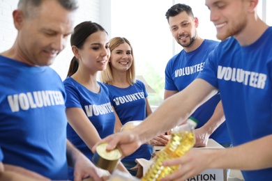 Photo of Team of volunteers collecting food donations indoors