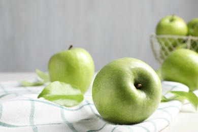 Photo of Fresh ripe green apples and napkin on table