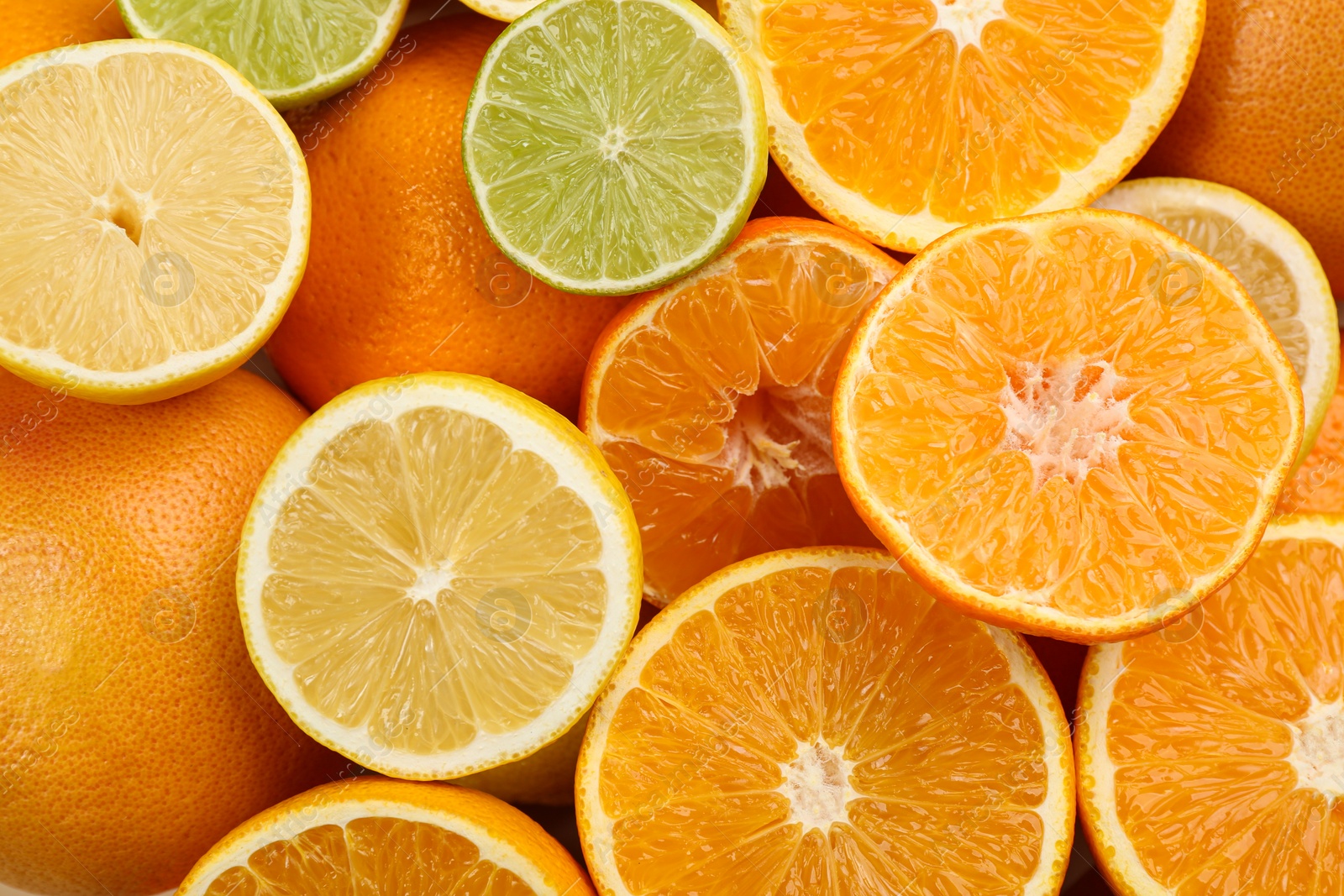 Photo of Tangerines and different citrus fruits as background, top view