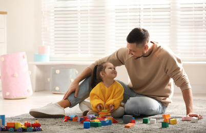 Photo of Father playing with his child at home