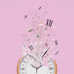 Image of Fleeting time concept. Analog clock dissolving on pink background