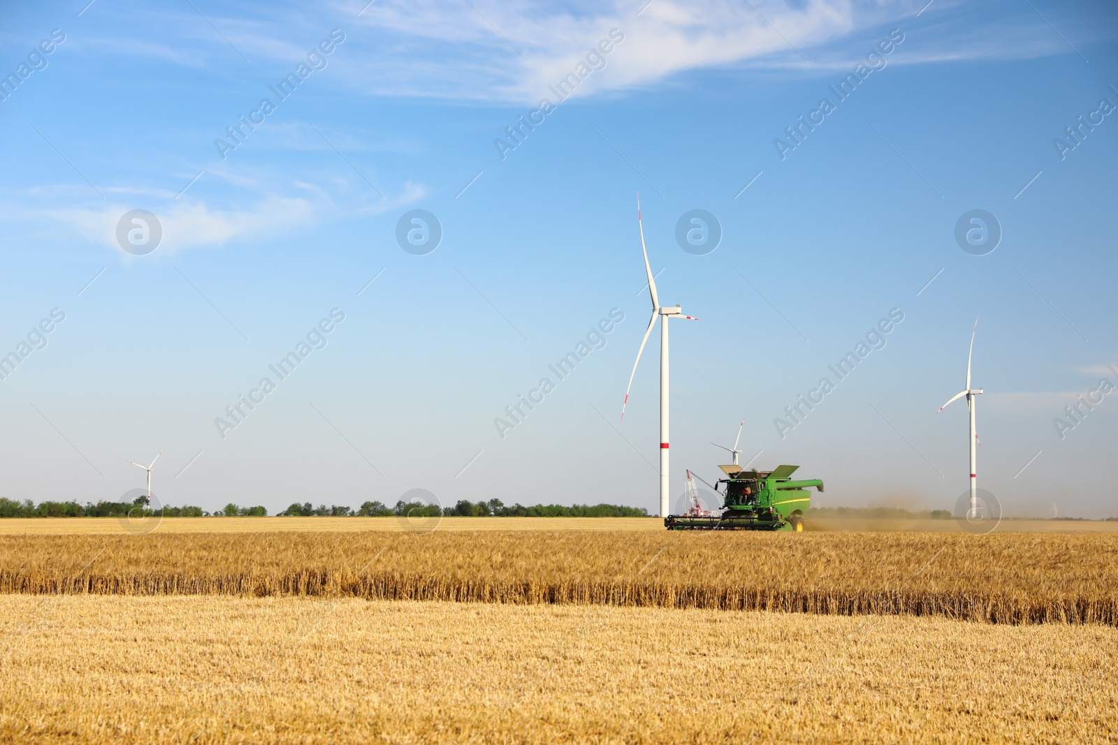 Photo of Modern combine harvester working in agricultural field