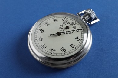 Photo of Vintage timer on blue background. Measuring tool