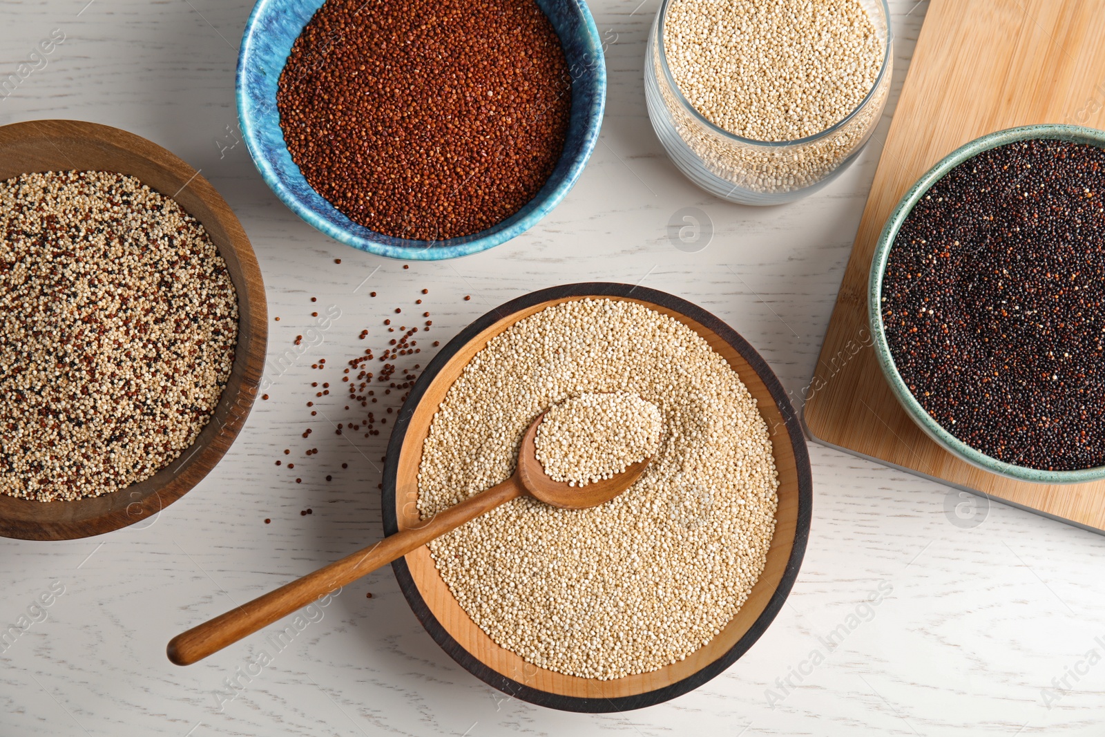 Photo of Flat lay composition with different types of quinoa on white wooden background