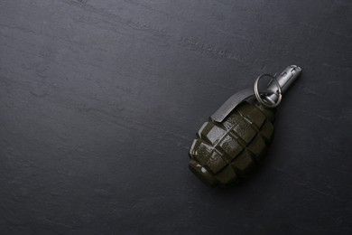 Hand grenade on black background, top view. Space for text