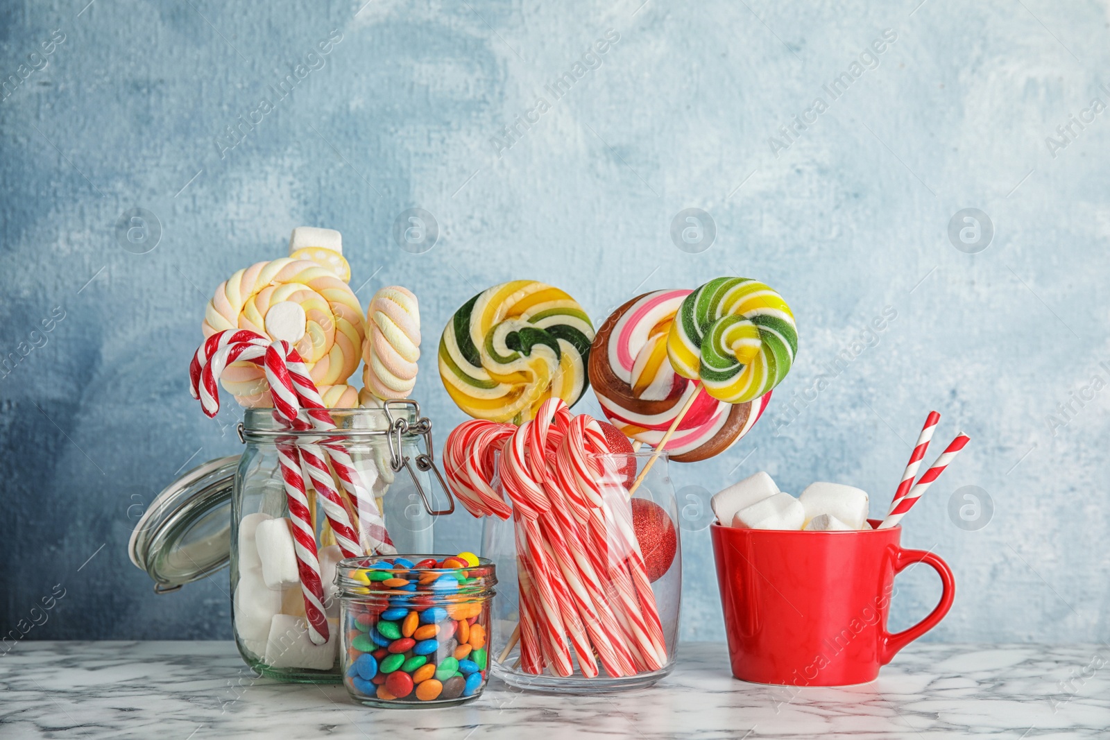 Photo of Composition with many different candies for party on table