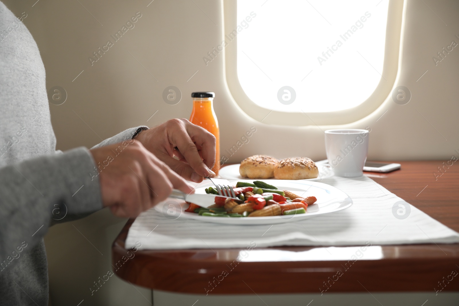 Image of Man eating during flight, closeup. Air travel