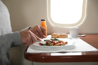 Man eating during flight, closeup. Air travel