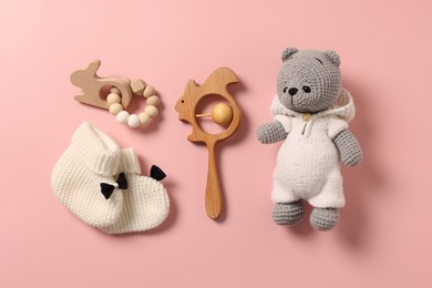 Baby accessories. Different toys and booties on pink background, flat lay