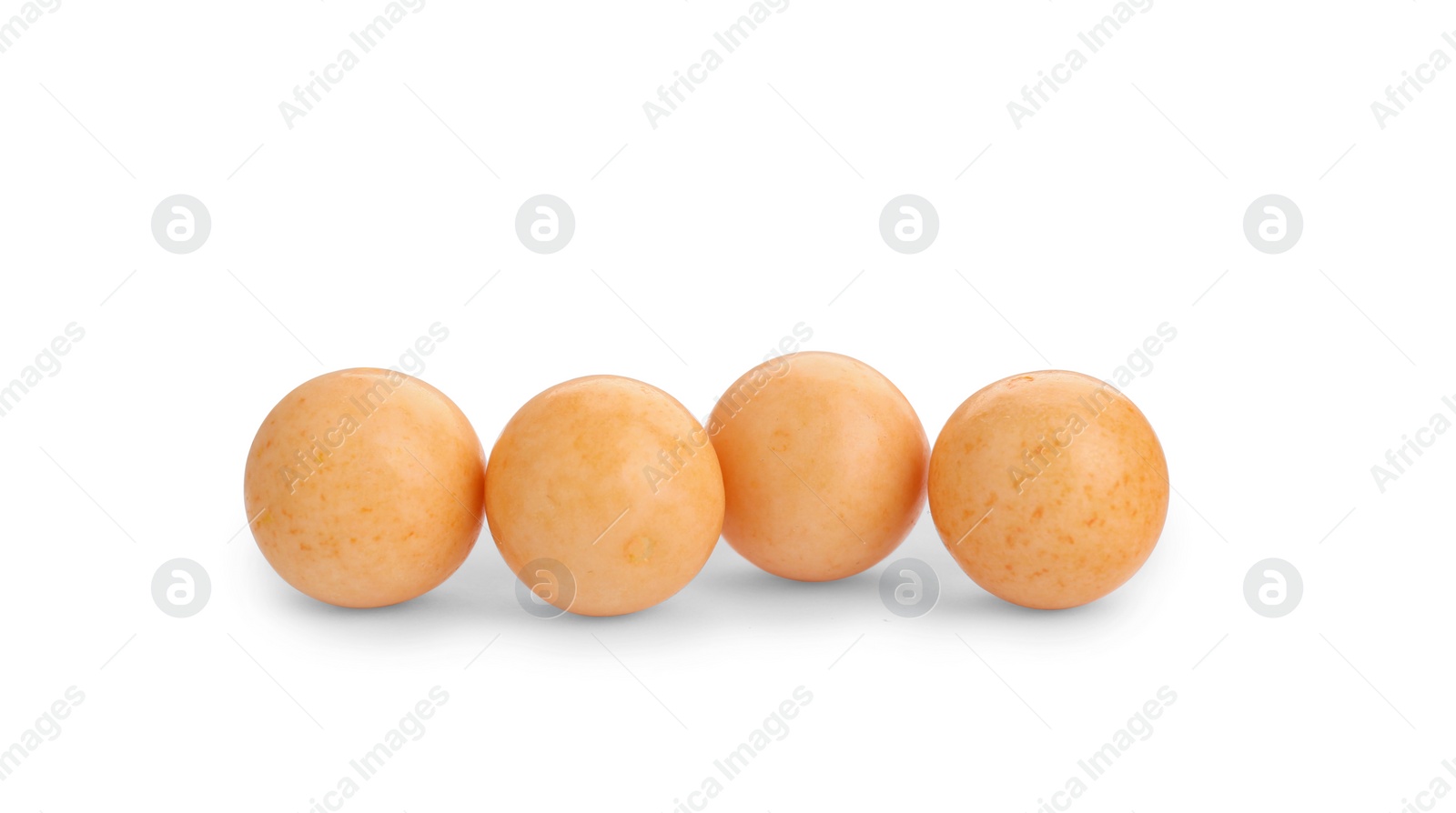 Photo of Bright orange chewy gumballs isolated on white