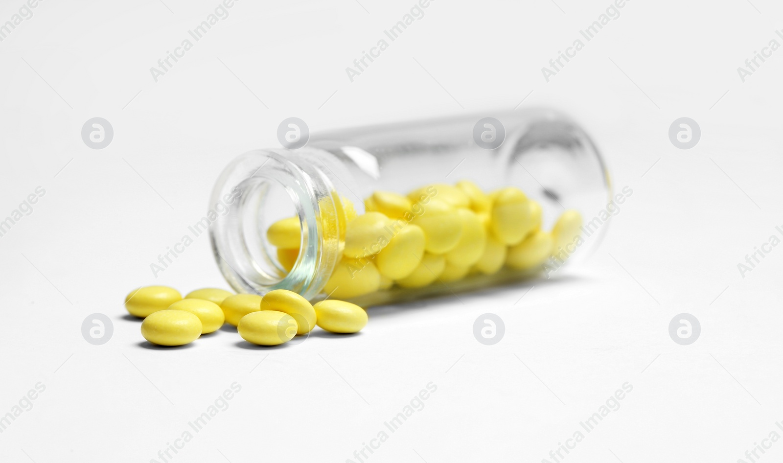 Photo of Pills and glass bottle on white background. Medical treatment