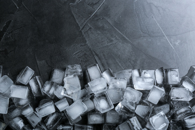 Ice cubes on grey table, flat lay. Space for text
