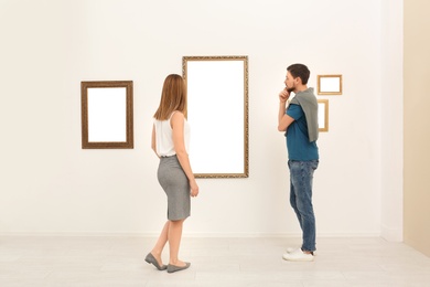 Photo of People viewing exposition in modern art gallery