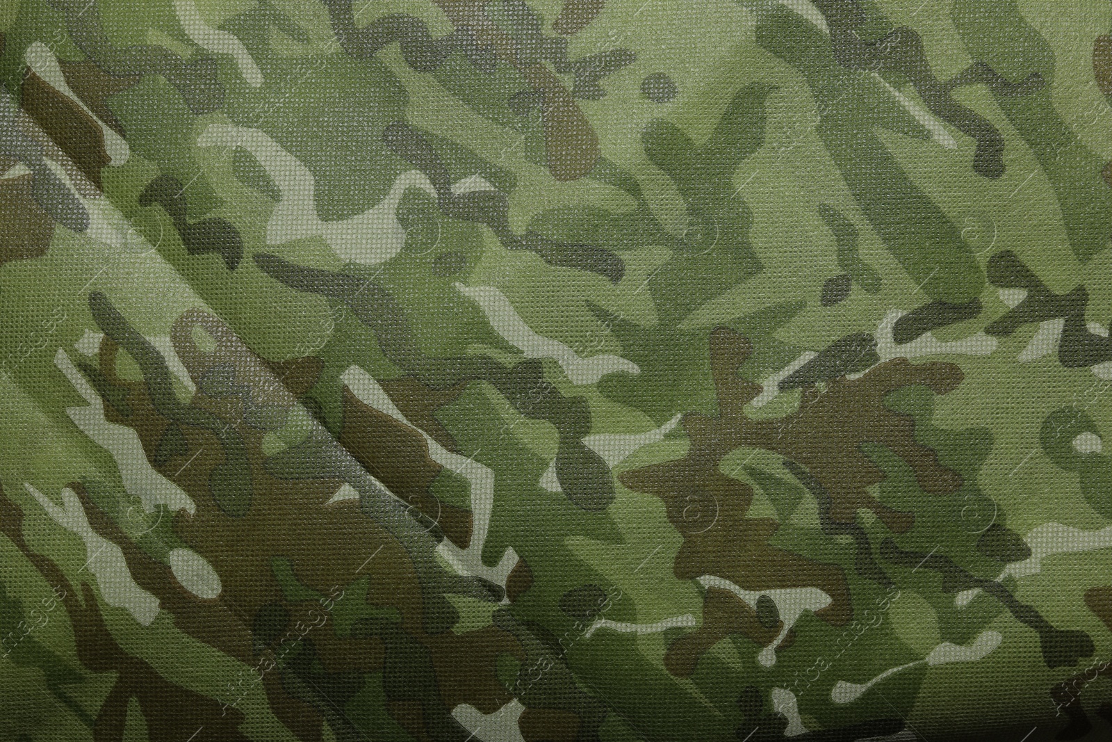 Photo of Texture of camouflage fabric as background, top view