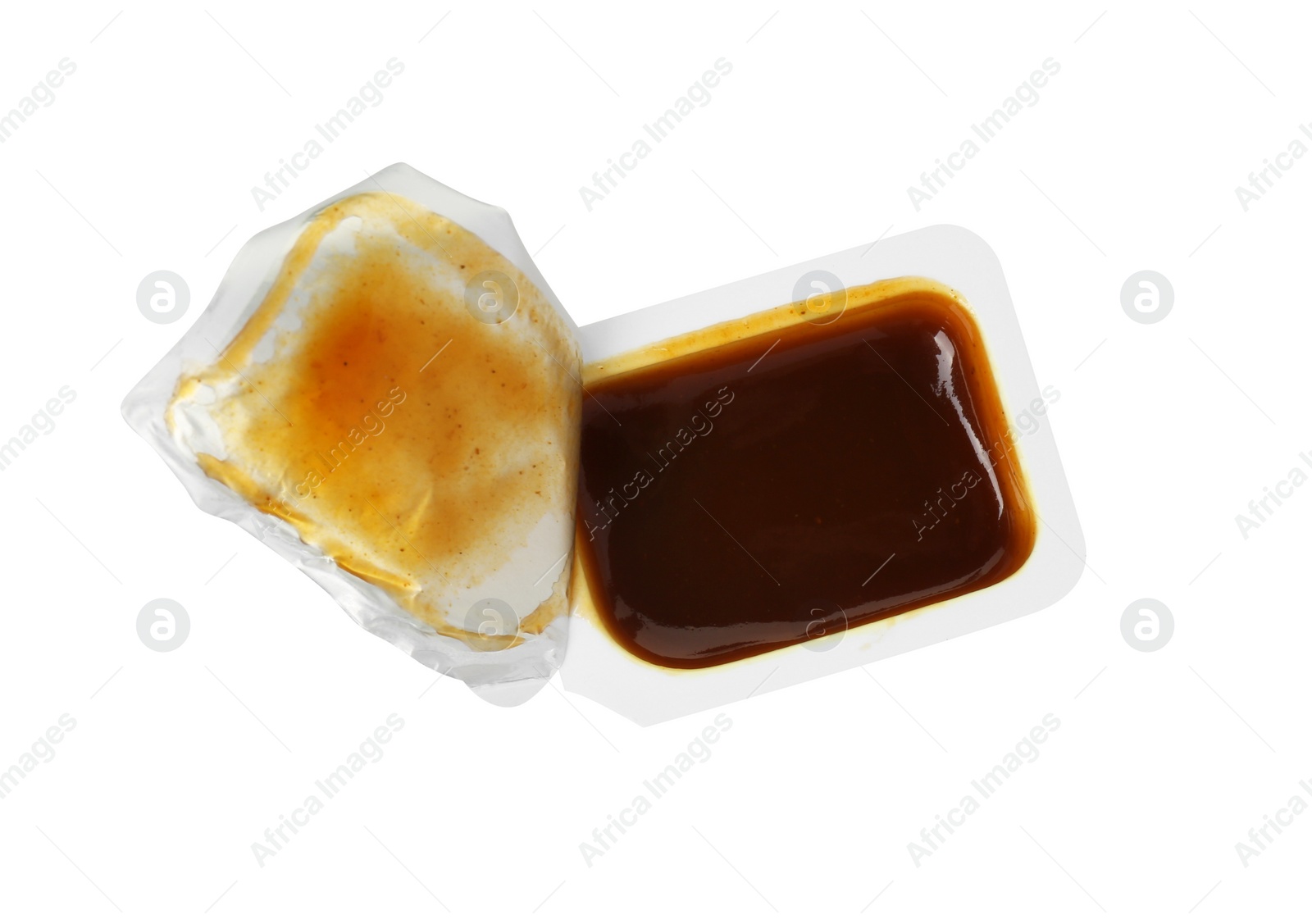 Photo of Tasty barbecue sauce in plastic container isolated on white, top view