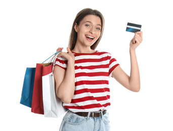 Photo of Young woman with credit card and shopping bags on white background. Spending money