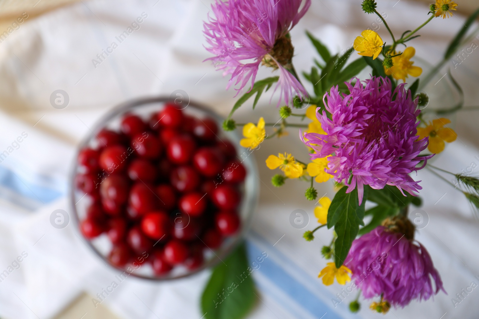 Photo of Bouquet of beautiful wildflowers on blurred background, top view. Space for text