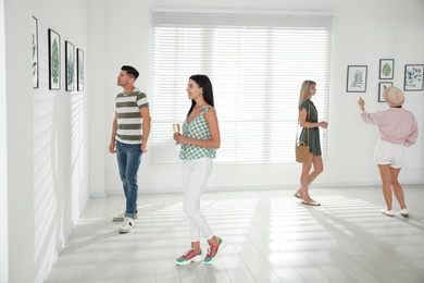 Group of people at exhibition in art gallery