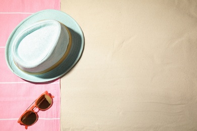 Photo of Composition with beach accessories and space for text on sand, flat lay