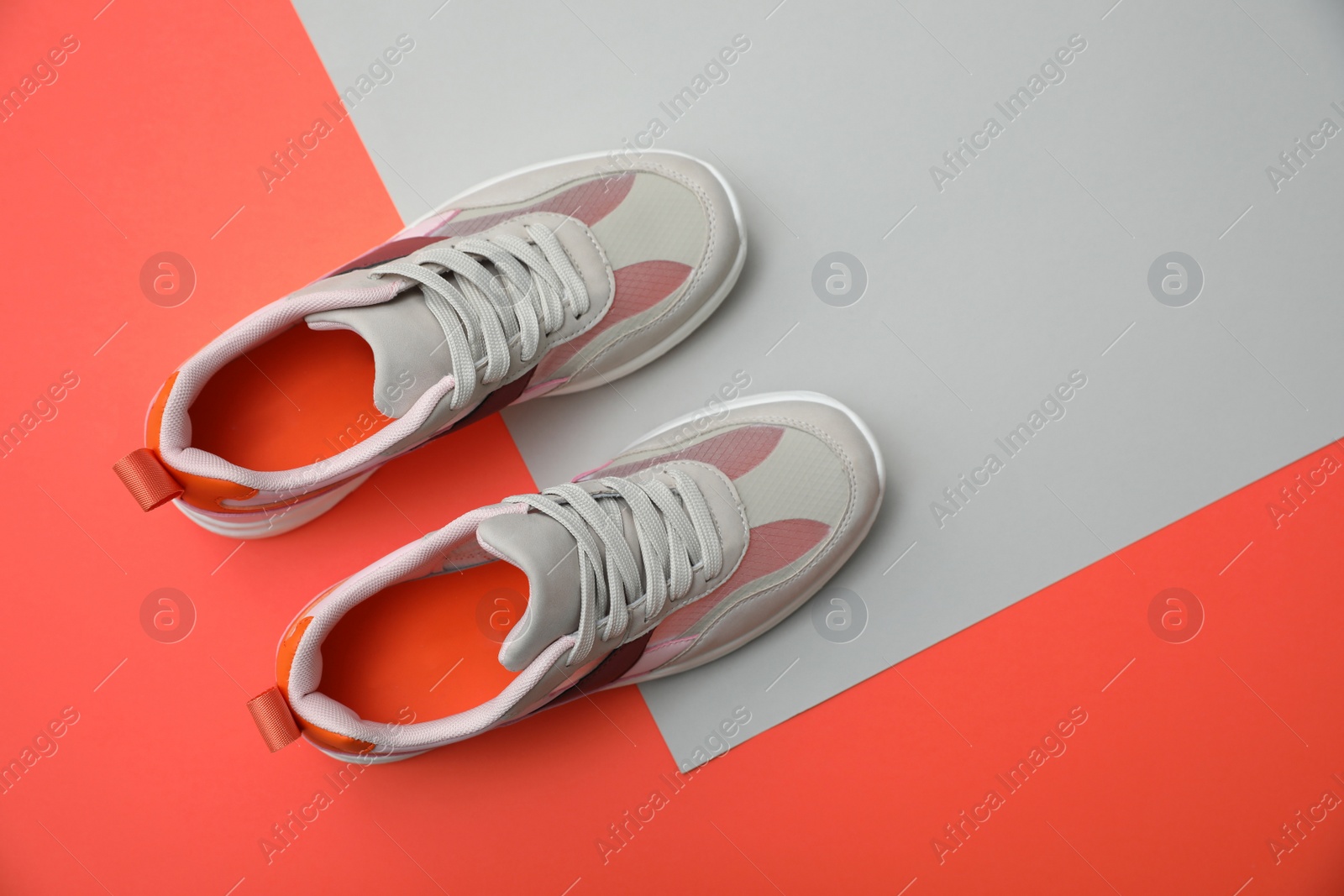 Photo of Stylish women's sneakers on color background, top view. Space for text