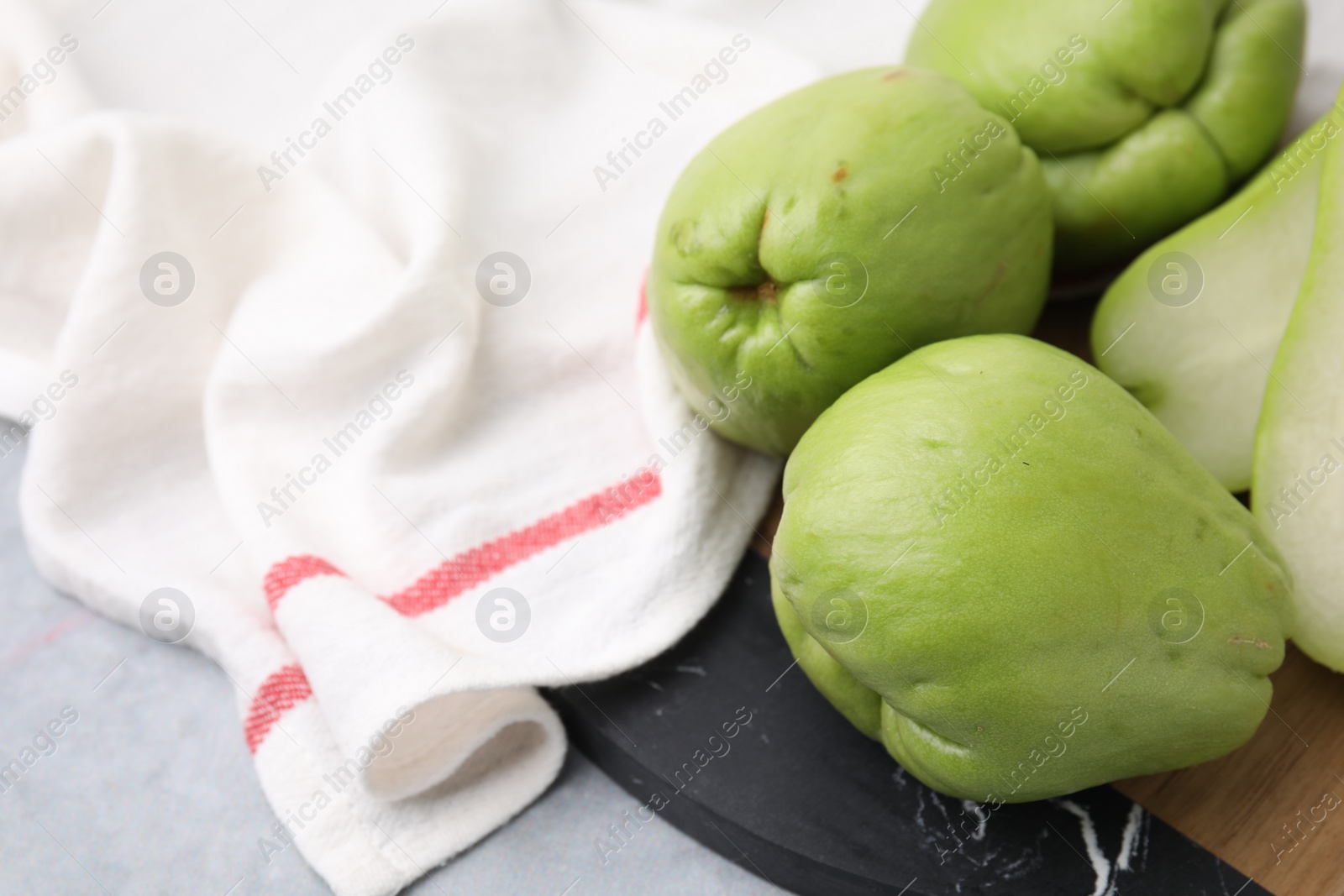 Photo of Fresh green chayote on gray table, closeup