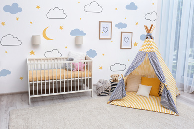 Cozy baby room interior with play tent and toys