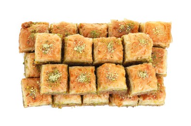 Photo of Delicious fresh baklava with chopped nuts isolated on white, top view. Eastern sweets