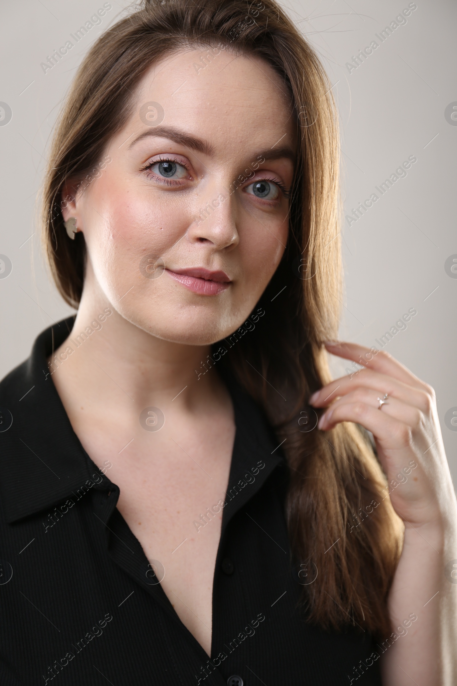 Photo of Portrait of beautiful young woman on beige background