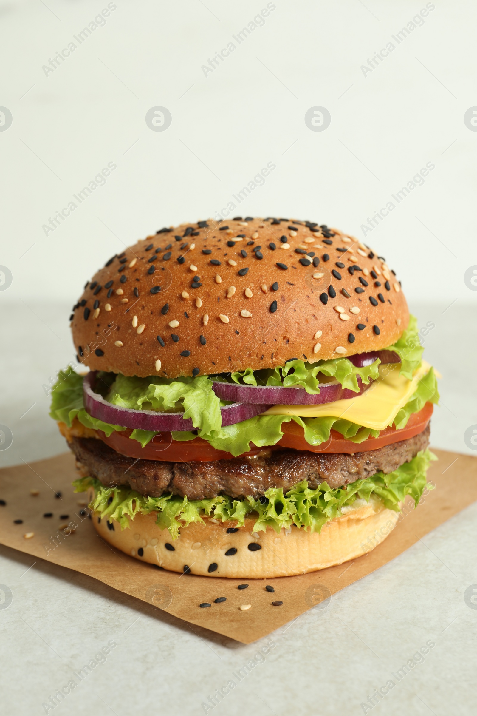 Burger with delicious patty on light table Photo of Burger with delicious patty on light table