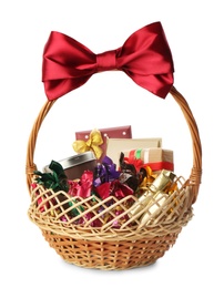 Photo of Wicker basket full of gifts isolated on white