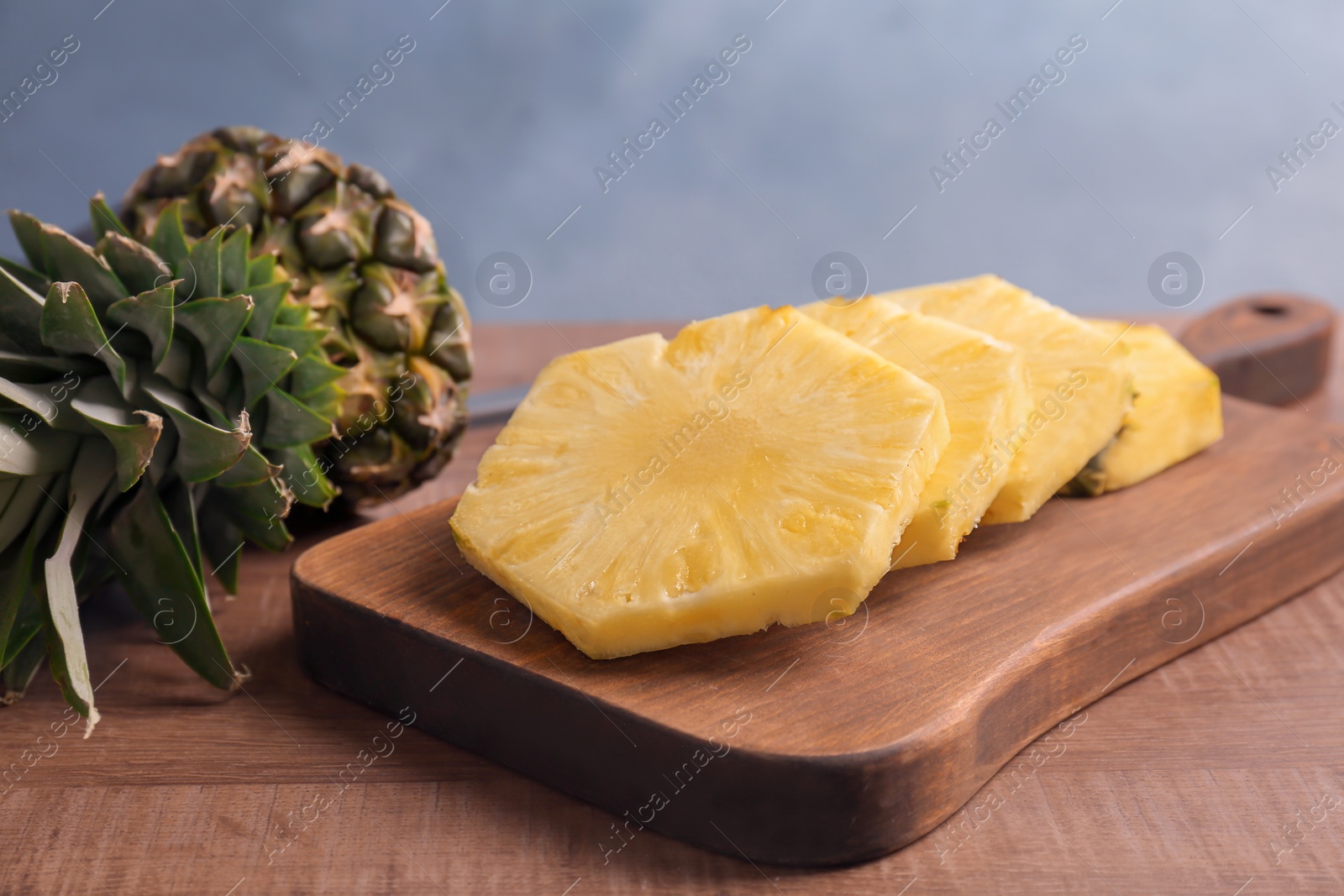 Photo of Cut fresh pineapple on wooden board