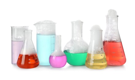 Photo of Laboratory glassware with colorful liquids isolated on white. Chemical reaction