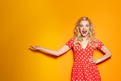 Emotional stylish young woman on color background