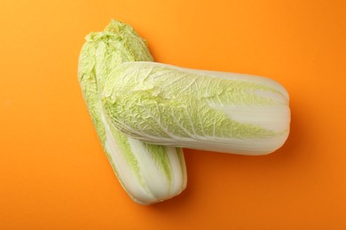 Photo of Fresh ripe Chinese cabbages on orange background, top view