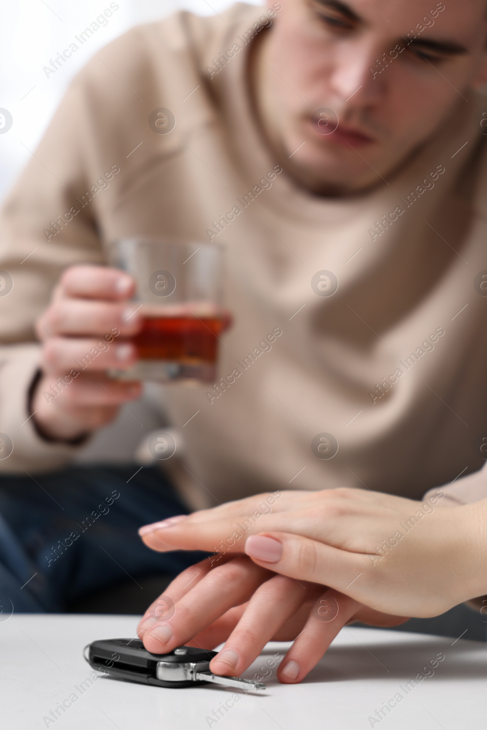 Photo of Woman stopping drunk man from taking car keys, closeup. Don't drink and drive concept