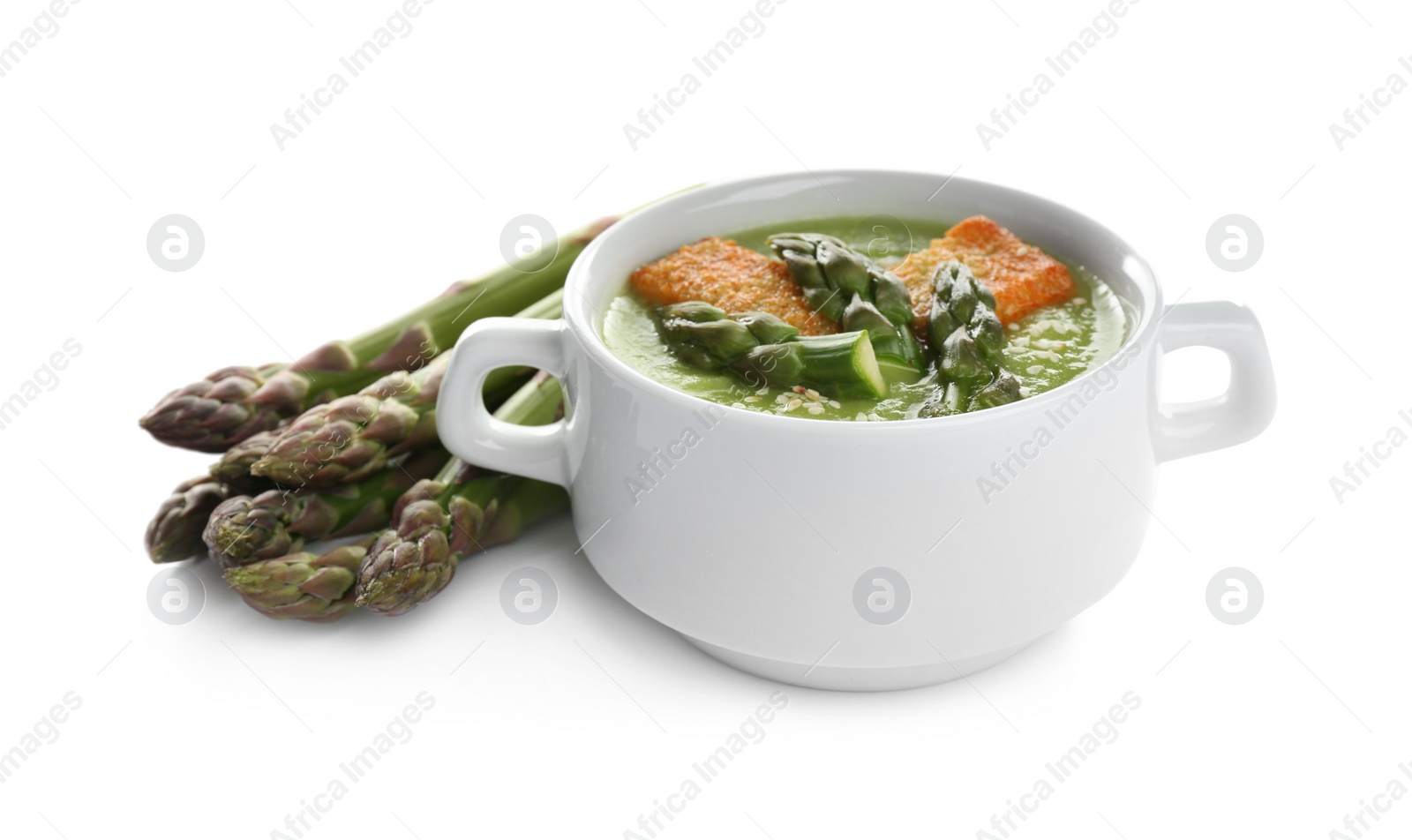 Photo of Delicious asparagus soup with rusks isolated on white