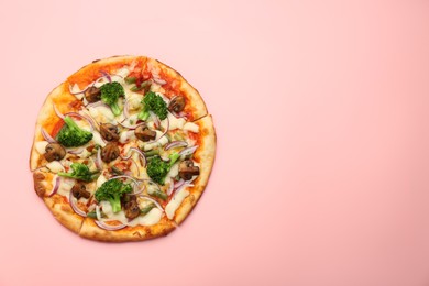 Photo of Delicious vegetarian pizza on pink table, top view. Space for text