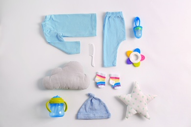 Photo of Set of baby clothes and accessories on light background, flat lay