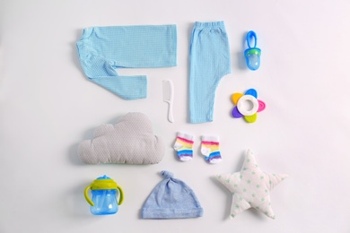 Set of baby clothes and accessories on light background, flat lay