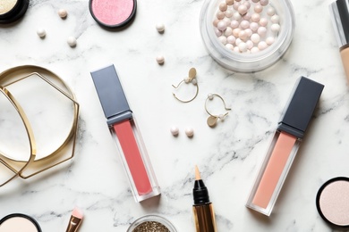 Beautiful composition with lipsticks and bijouterie on light background, flat lay