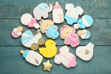 Photo of Set of baby shower cookies on light blue wooden table, flat lay