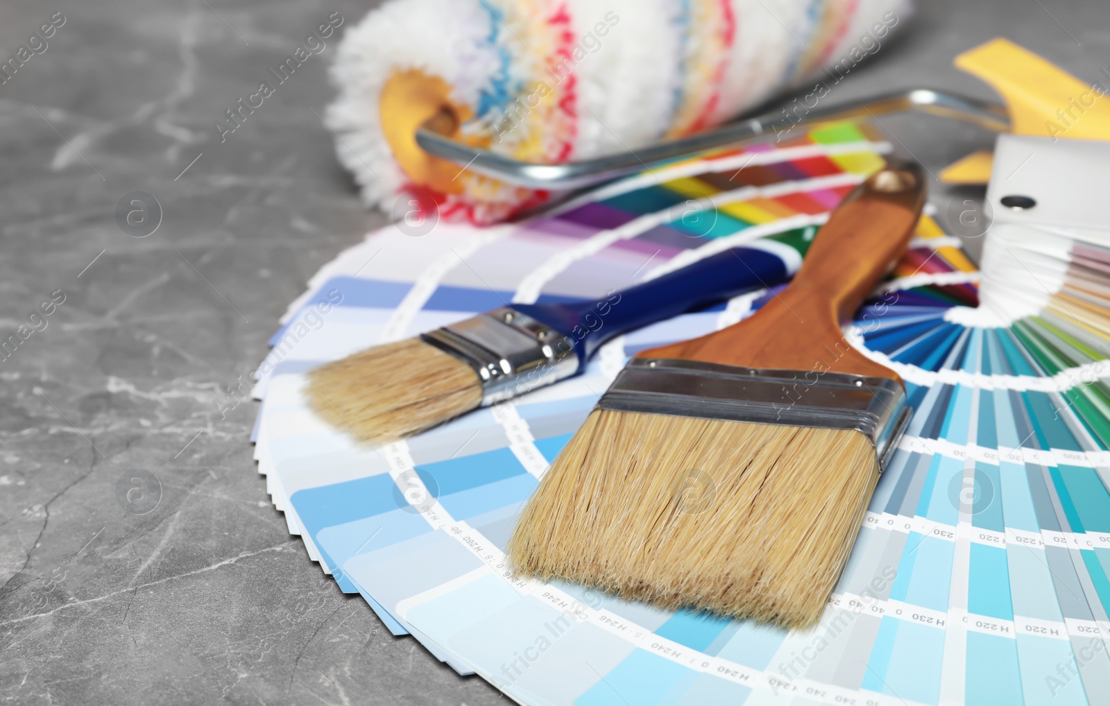 Photo of Set of decorator's tools on grey background